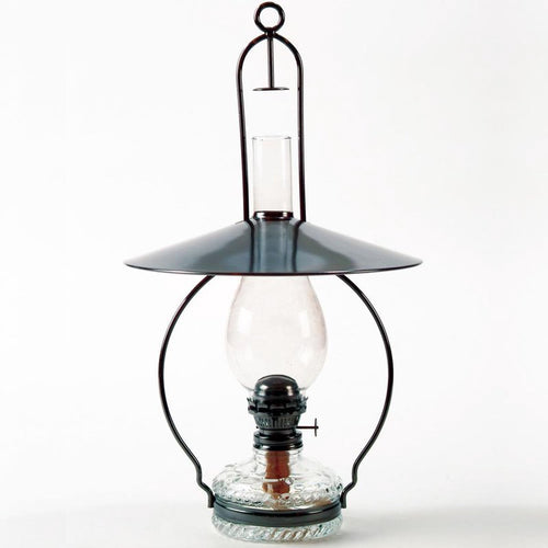 Handcrafted hanging oil lamp with antiqued steel frame, top reflector directing light downward, clear glass chimney, and decorative embossed base, ideal for farm, garden, and homesteading.