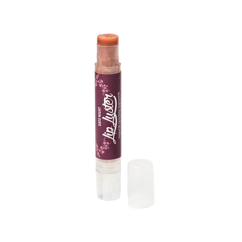Handcrafted all-natural lip luster in a clear twist-up tube with a dark purple label, part of Health & Wellness and USA Made collections, offering creamy lip care and shine.