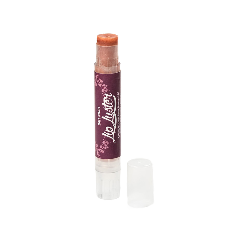 Handcrafted all-natural lip luster in a clear twist-up tube with a dark purple label, part of Health & Wellness and USA Made collections, offering creamy lip care and shine.