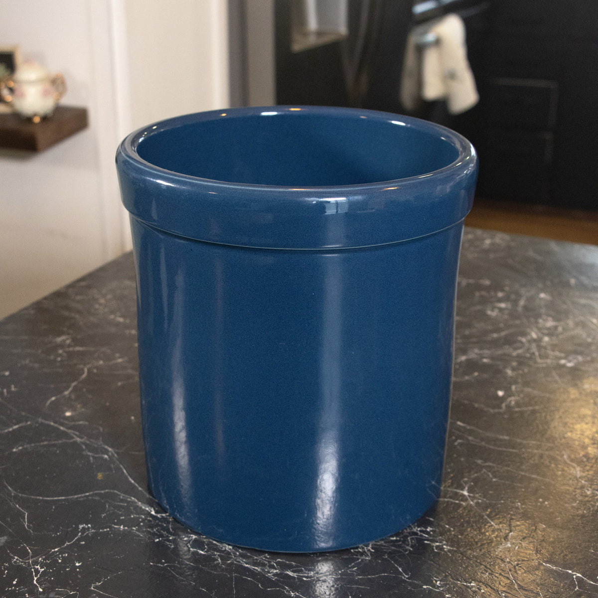 Deep blue stoneware crock with a smooth, food-safe glaze, handcrafted in the USA and ideal for fermenting and food preservation in kitchen and dining spaces.