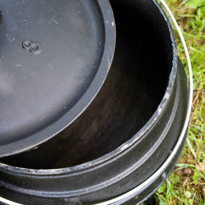 Handcrafted cast iron campfire kettle with a round lid and sturdy construction, designed for outdoor cooking in Farm, Garden & Tool, Camping, Best Sellers, and Promo Eligible collections.