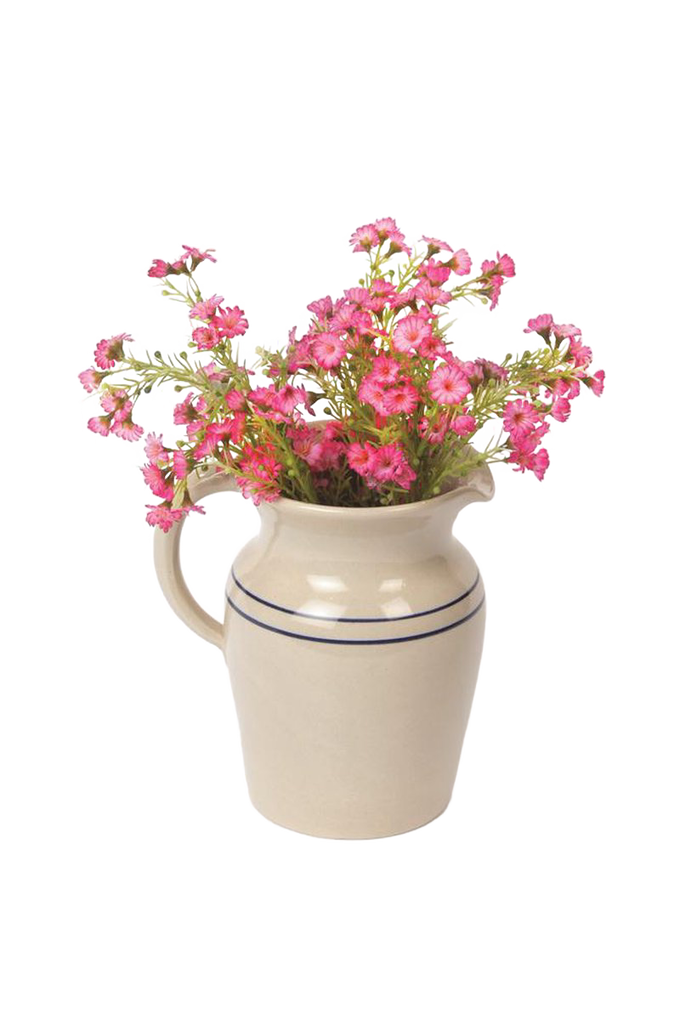 Handcrafted cream stoneware pitcher with two blue stripes, filled with vibrant pink flowers, made in USA, ideal for Kitchen & Food, Dinnerware, Holiday Hosting, Storage and Serving collections.