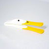 Plastic toast tongs shaped like a duck with a yellow heat-resistant silicone beak and ergonomic handle, designed for kitchen use and serving hot toast safely.