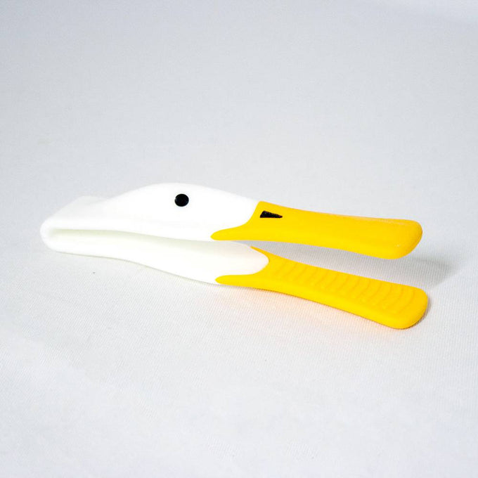 Plastic toast tongs shaped like a duck with a yellow heat-resistant silicone beak and ergonomic handle, designed for kitchen use and serving hot toast safely.