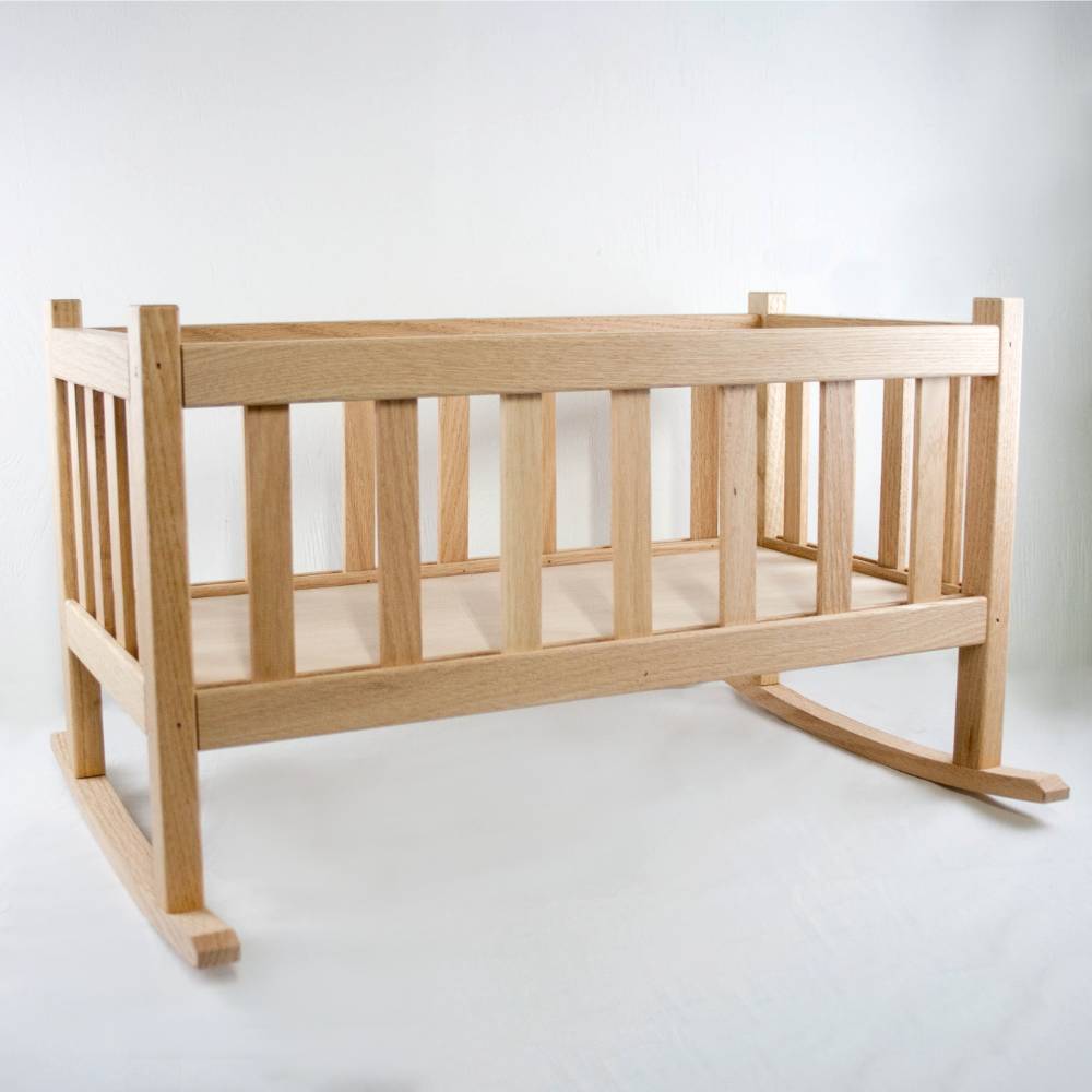 Smooth solid oak doll cradle with slatted sides and gentle rocking base, handcrafted by Amish woodworkers for durable indoor play in children's toys and doll accessories collections.