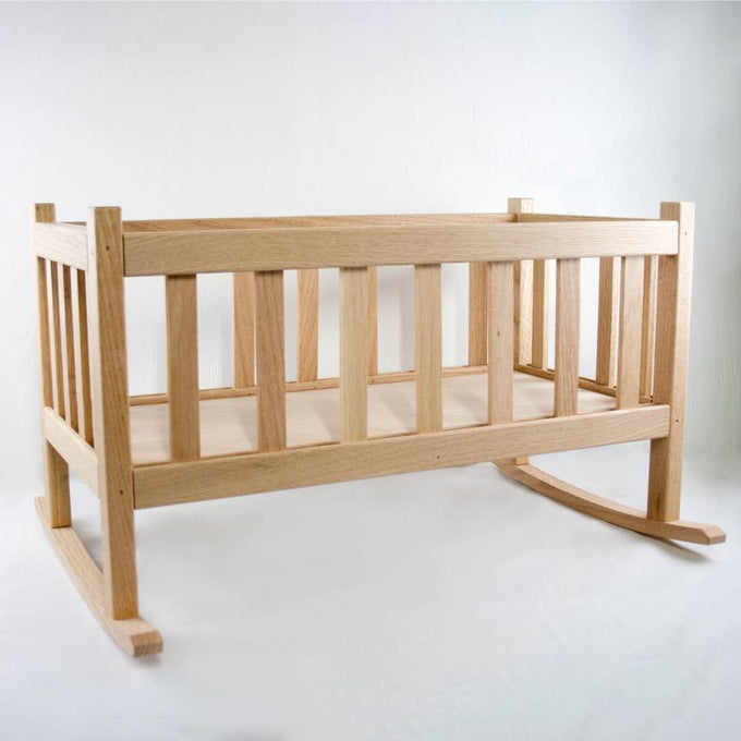 Smooth solid oak doll cradle with slatted sides and gentle rocking base, handcrafted by Amish woodworkers for durable indoor play in children's toys and doll accessories collections.