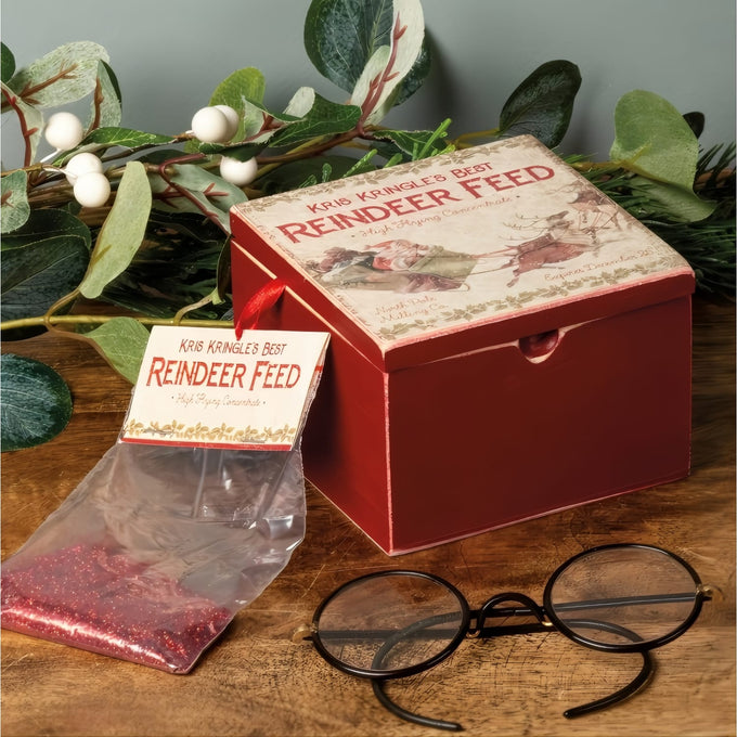 Handcrafted hinged box with vintage-inspired holiday label and packet of festive glitter "reindeer feed," styled with round glasses and greenery for Home & Decor, Holiday Decor, Best Sellers, Promo Eligible collections.