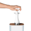 Hand using a white ergonomic ice cream scoop with a stainless steel edge to lift a portion of ice cream from a container, ideal for kitchen and food, cookware, and baking supplies collections.