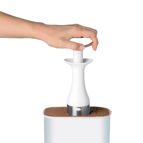 Hand using a white ergonomic ice cream scoop with a stainless steel edge to lift a portion of ice cream from a container, ideal for kitchen and food, cookware, and baking supplies collections.