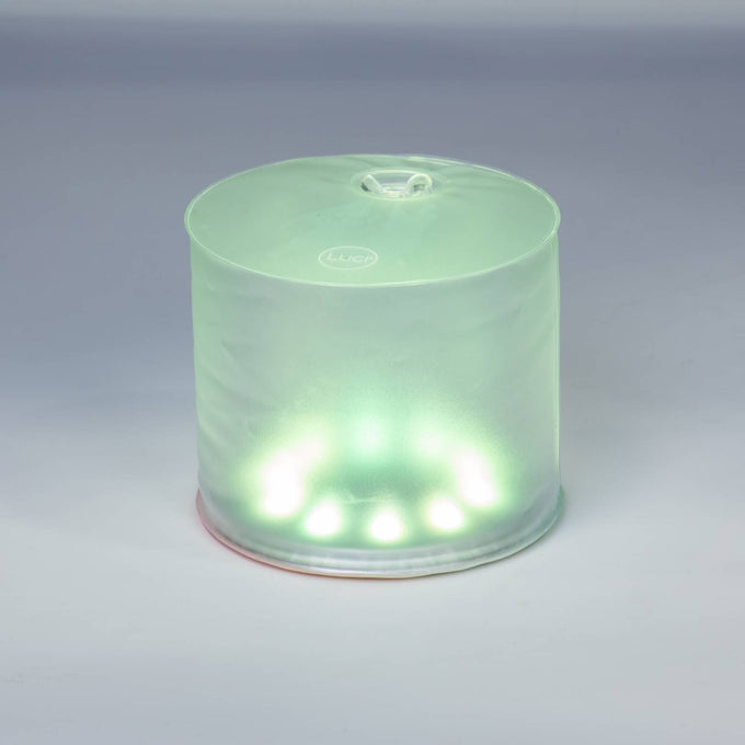 Compact inflatable solar LED light glowing with soft green hue, designed for eco-friendly use in camping, emergency supplies, Farm, Garden & Tool, and outdoor lighting needs.