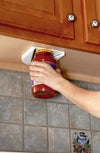 Hand securing a jar in a white vise mounted under a wooden kitchen cabinet, designed to help open stubborn jar lids easily, featured in Kitchen Gadgets and Accessories collections.