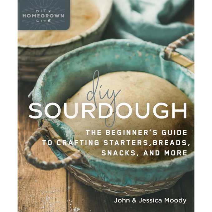 Rustic woven basket with risen sourdough dough resting inside a vintage blue cloth, representing beginner-friendly bread making in Books, Cookbooks, and Home and Garden How-To Books collections.