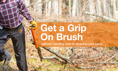 Person using a handcrafted orange log hauler tool to lift and roll brush in a wooded outdoor setting, designed for wood cutting and hauling with ergonomic benefits for farm, garden, and tool collections.