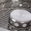 Close-up of the stainless steel fire bowl and inner ventilation component with a sturdy metal grill, showcasing the double-wall construction designed for even heat and low smoke in outdoor use.