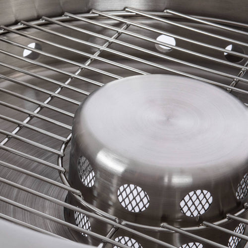 Close-up of the stainless steel fire bowl and inner ventilation component with a sturdy metal grill, showcasing the double-wall construction designed for even heat and low smoke in outdoor use.
