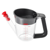 Clear plastic fat separator with black cushioned handle and red stopper, featuring measurement markings and strainer inside, perfect for Kitchen & Food and Cooking and Baking Helpers collections.