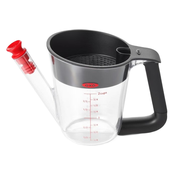 Clear plastic fat separator with black cushioned handle and red stopper, featuring measurement markings and strainer inside, perfect for Kitchen & Food and Cooking and Baking Helpers collections.