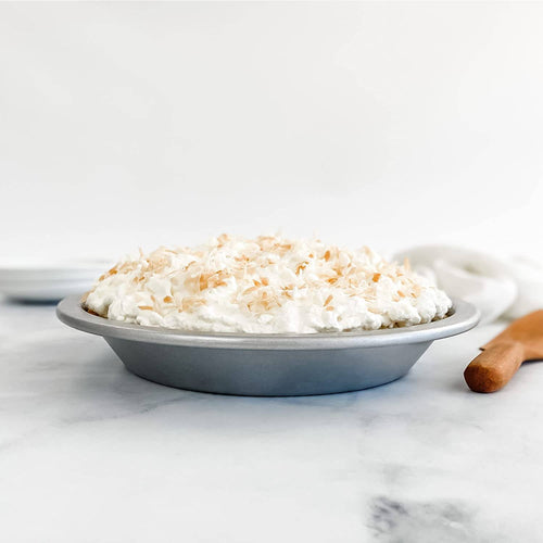 9-inch aluminized steel pie pan filled with a whipped cream topped pie, showcasing even baking performance, ideal for Kitchen & Food, Baking Supplies, and USA Made collections.