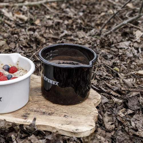 Black enameled steel milk pot with pour spout and white volume markings, handmade for durable use in outdoor kitchens, camping, farm, garden, cookware, and best sellers collections.