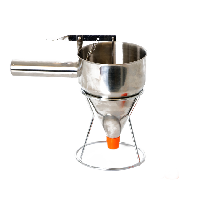 Stainless steel batter dispenser with thumb lever and stand, featuring a sealed silicone inner plug and orange tip, designed for precise batter control in baking and cooking.