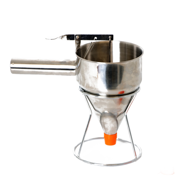 Stainless steel batter dispenser with thumb lever and stand, featuring a sealed silicone inner plug and orange tip, designed for precise batter control in baking and cooking.