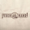 Close-up of the Feuerhand logo embroidered on weather-resistant ripstop fabric in light beige, featured in Farm, Garden & Tool and Camping collections.