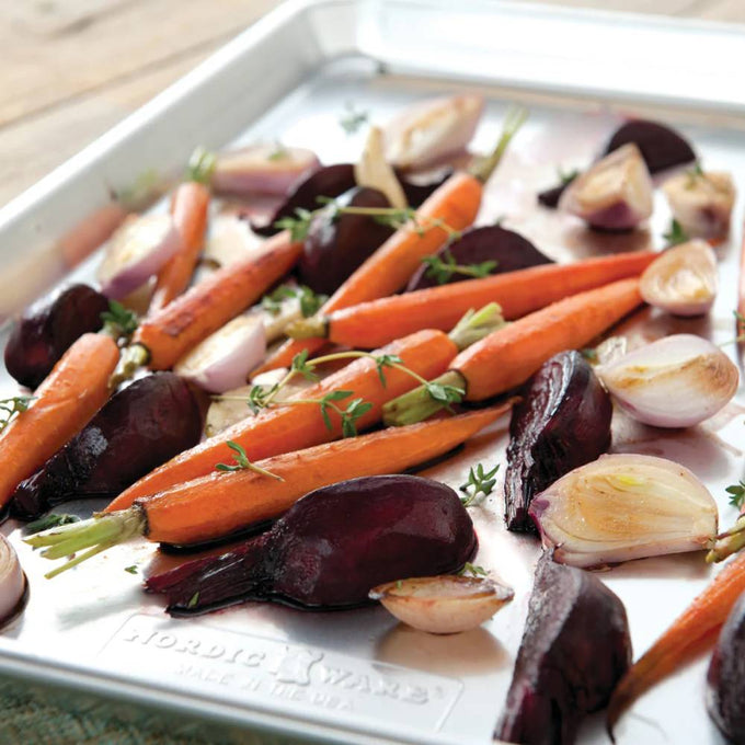 Aluminum half sheet pan with roasted baby carrots, beets, and garlic cloves, garnished with fresh thyme, featured in Kitchen & Food, Cookware, Baking Supplies, and USA Made collections.