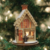 Handcrafted wooden miniature toy shop ornament with intricate details, including tiny rocking horses and a gingerbread figure, perfect for holiday decor and home accents.