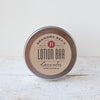 Round metal tin of handcrafted lotion bar with natural lavender scent, made in USA, featured in Health & Wellness, Balms, Creams and Lotions, Grooming and Personal Hygiene, USA Made, Best Sellers, and Promo Eligible collections.