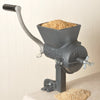 Heavy-duty hand-cranked grain mill with a large hopper filled with dry grains, sturdy cast iron construction, and secure clamp base, crafted for Kitchen & Food, Grain Mills, and USA Made collections.