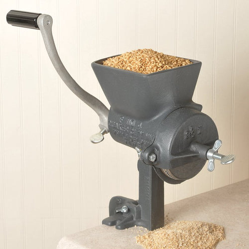 Heavy-duty hand-cranked grain mill with a large hopper filled with dry grains, sturdy cast iron construction, and secure clamp base, crafted for Kitchen & Food, Grain Mills, and USA Made collections.