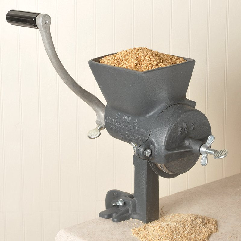 Heavy-duty hand-cranked grain mill with a large hopper filled with dry grains, sturdy cast iron construction, and secure clamp base, crafted for Kitchen & Food, Grain Mills, and USA Made collections.