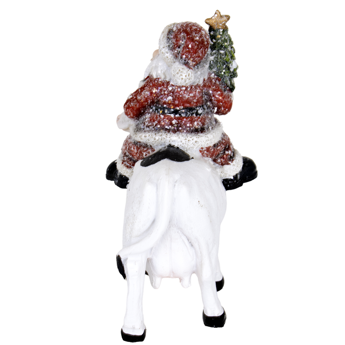 Unique handcrafted 6-inch resin figurine featuring Santa holding a Christmas tree while riding a white cow, ideal for adding festive country charm to Home & Decor, Holiday Decor, Best Sellers, and Promo Eligible collections.