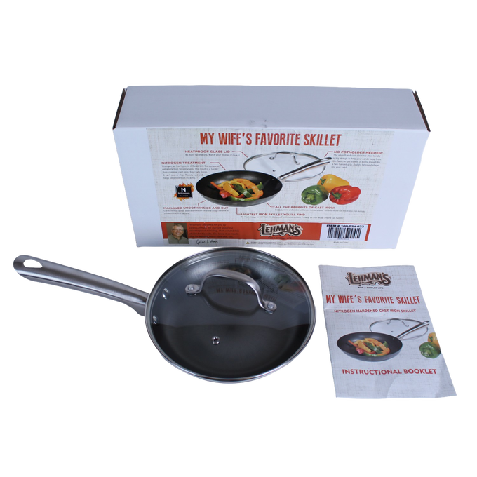 Handcrafted nitrogen hardened cast iron skillet with smooth stainless steel handle and clear tempered glass lid, shown with instructional booklet and packaging, featured in Kitchen & Food, Cookware, Cast Iron, and Best Sellers collections.