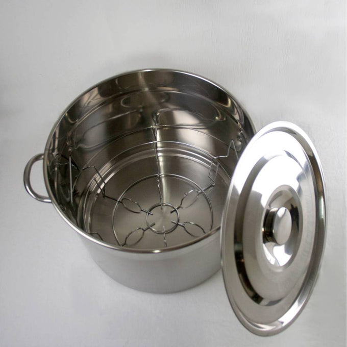 Shiny stainless steel 20-quart canner and stockpot with lid, featuring a sturdy wire rack, ideal for food preservation, water bath canning, and versatile kitchen use in canning and pots collections.