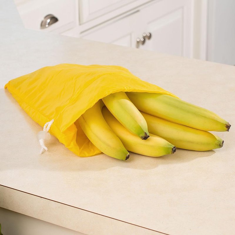 Bright yellow fabric bag with a drawstring closure holding six ripe bananas, designed for kitchen storage and food preservation, featured in Best Sellers and Promo Eligible collections.