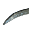 Close-up of a handcrafted curved metal blade with a pointed tip and decorative patterns, designed for effective cutting in farm, garden, and lawncare tasks.