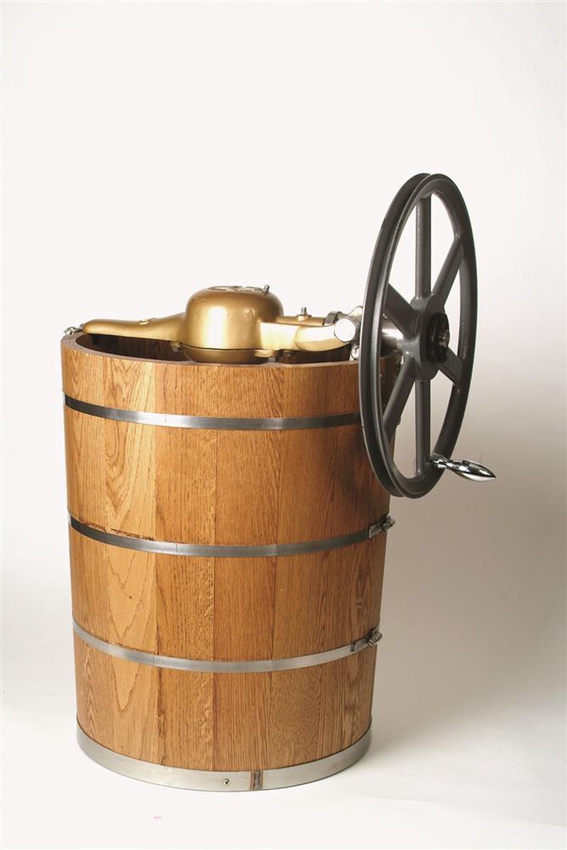 Large wooden ice cream freezer with sturdy metal bands and a tall hand-crank wheel, designed for specialty kitchen use and made in the USA collection.