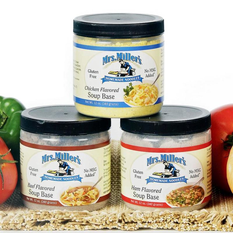 Three 12-oz canisters of handcrafted Amish-made soup bases in chicken, beef, and ham flavors, gluten-free and no MSG, displayed with fresh vegetables for Kitchen & Food, Dry Goods and Mixes, Soups, Gluten Free, USA Made, Best Sellers, and Promo Eligible collections.