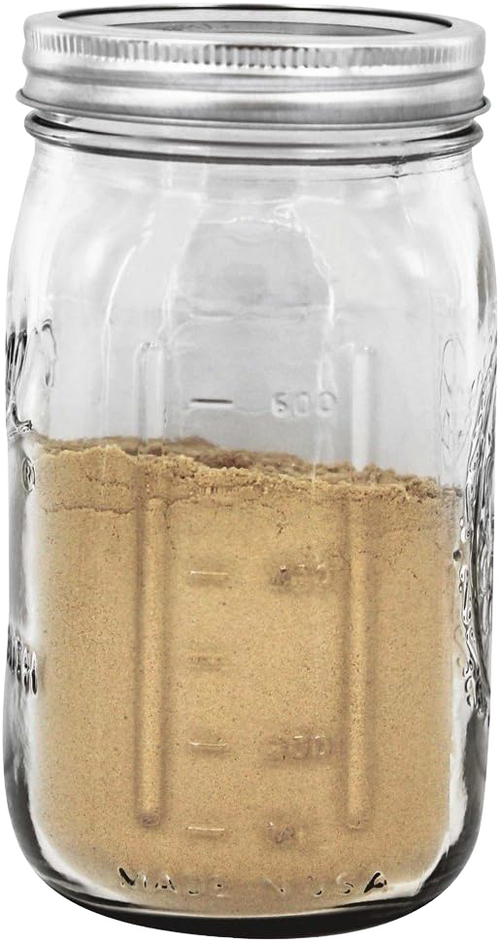 Clear wide-mouth quart jar with metal lid, partially filled with brown powder, handcrafted and made in USA, suited for Kitchen & Food, Food Preservation, and Canning collections.