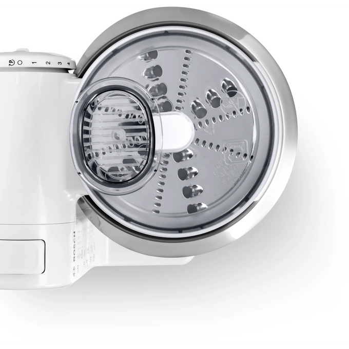 Close-up of a stainless steel slicer shredder attachment with clear plastic feeding chute, designed for efficient vegetable and cheese prep in Kitchen & Food and USA Made collections.