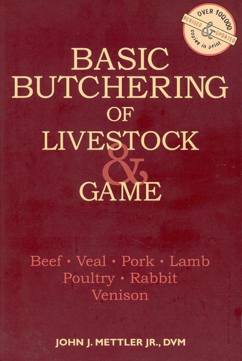 Cover of a handcrafted book titled Basic Butchering of Livestock & Game by John J. Mettler Jr., featuring a deep red background, focusing on beef, veal, pork, lamb, poultry, rabbit, and venison, popular in Toys, Books & Games and Farm and Livestock Books collections.