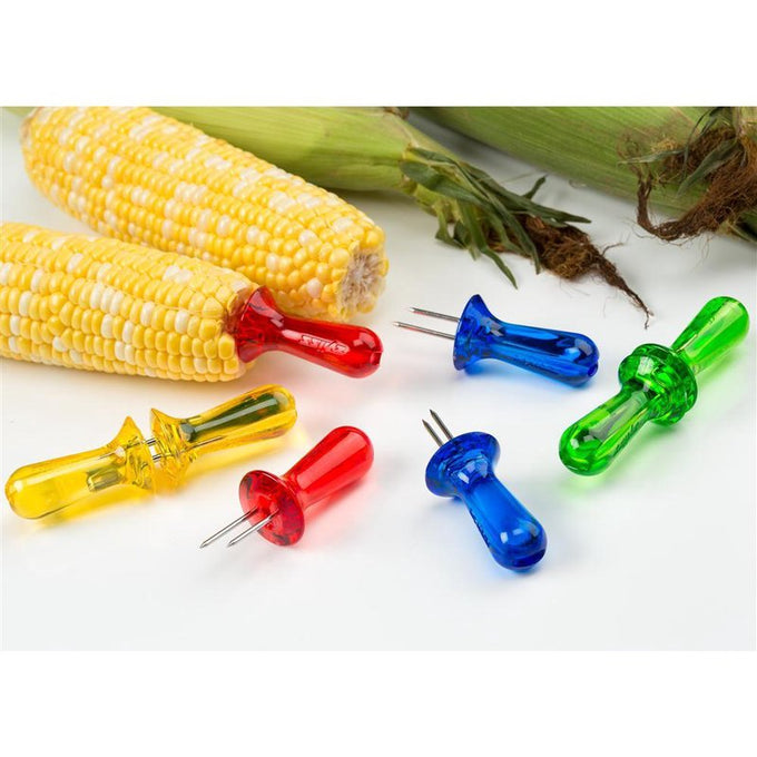 Colorful translucent corn holders with stainless steel pins and tough plastic handles shown with fresh corn on the cob, designed for easy use and storage in Kitchen & Food and Kitchen Accessories collections.