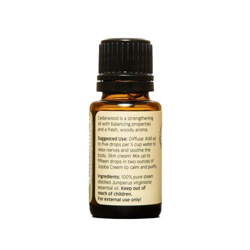 Amber glass bottle of handcrafted cedarwood essential oil with black cap and detailed label, made in USA, perfect for aromatherapy, soapmaking, candlemaking, and health remedies collections.