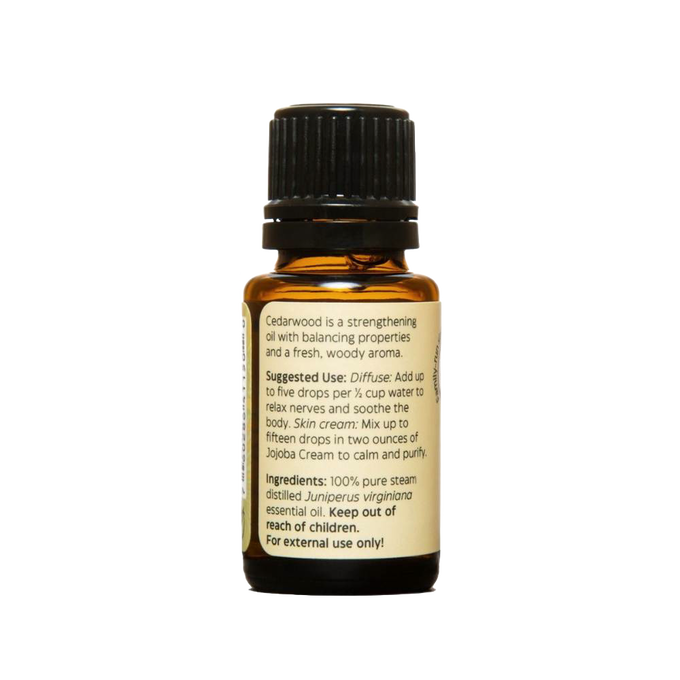 Amber glass bottle of handcrafted cedarwood essential oil with black cap and detailed label, made in USA, perfect for aromatherapy, soapmaking, candlemaking, and health remedies collections.