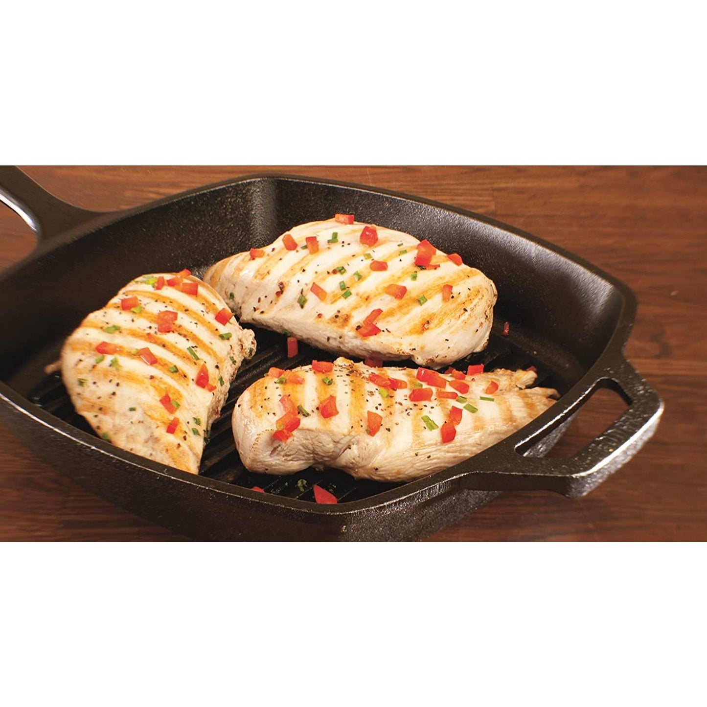 Square cast iron grill pan with seared chicken breasts garnished with chopped red peppers and herbs, showcasing even heating and heat retention for Kitchen & Food, Cookware, Cast Iron, USA Made collections.