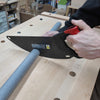 Hand tool with carbon steel curved blade and ergonomic black and red handle cutting gray foam pipe insulation on wooden workbench, featured in Farm, Garden & Tool and Best Sellers collections.