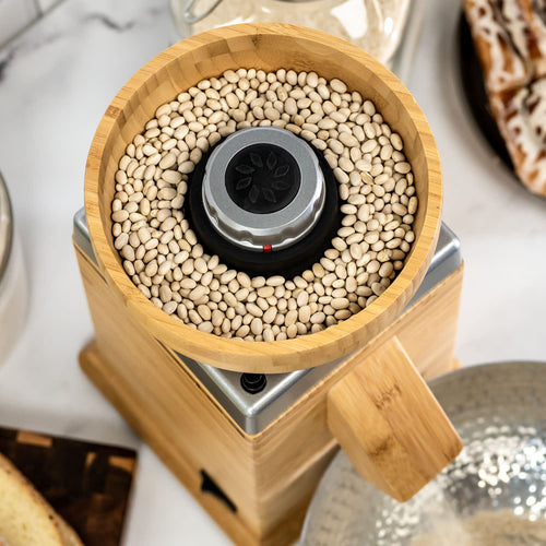 Top view of a natural bamboo grain hopper filled with white beans inside an electric grain mill, featured in Kitchen & Food, Grain Mills, Best Sellers, and Bread Making Supplies collections.