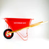 Durable child's wheelbarrow with sturdy wood handles, bright red poly bed, metal frame, and rubber tire, crafted for real use, featured in Toys, Books & Games and Lawn Games collections.