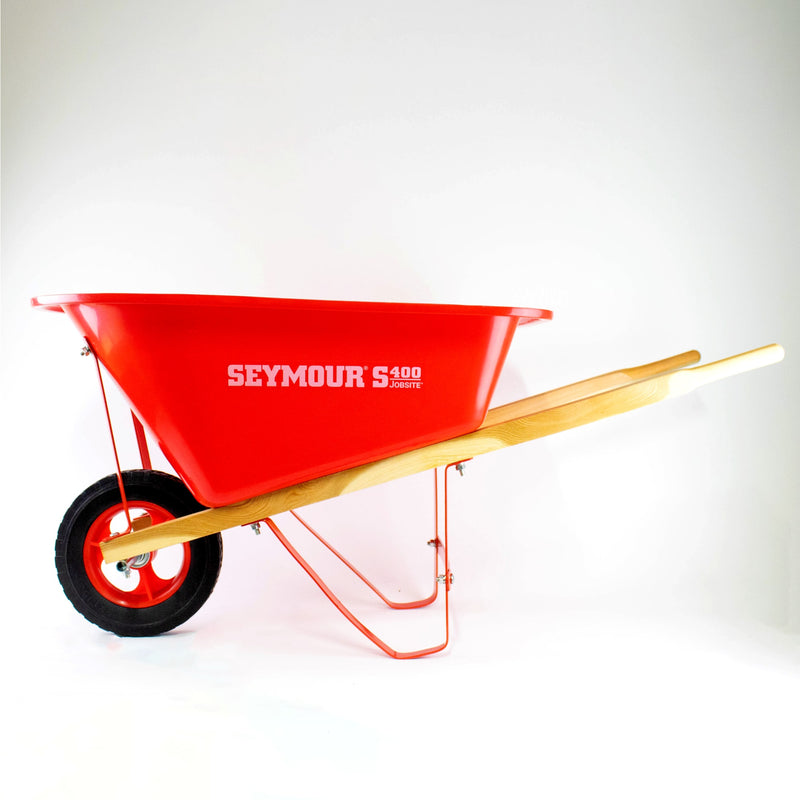 Durable child's wheelbarrow with sturdy wood handles, bright red poly bed, metal frame, and rubber tire, crafted for real use, featured in Toys, Books & Games and Lawn Games collections.